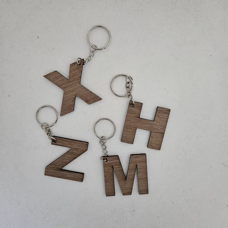 Porte clé en bois noyer lettre X Z M H découpé au laser attaché à un anneau métallique